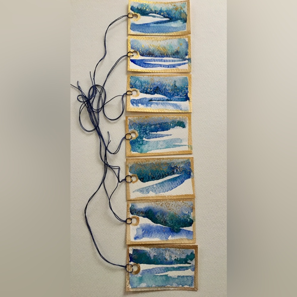 Set of 6 hand painted watercolor tags .